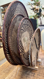 Set of 4 handwoven Binga baskets from Zimbabwe in varying sizes - styled as natural wall décor in Dubai and Middle Eastern homes.
