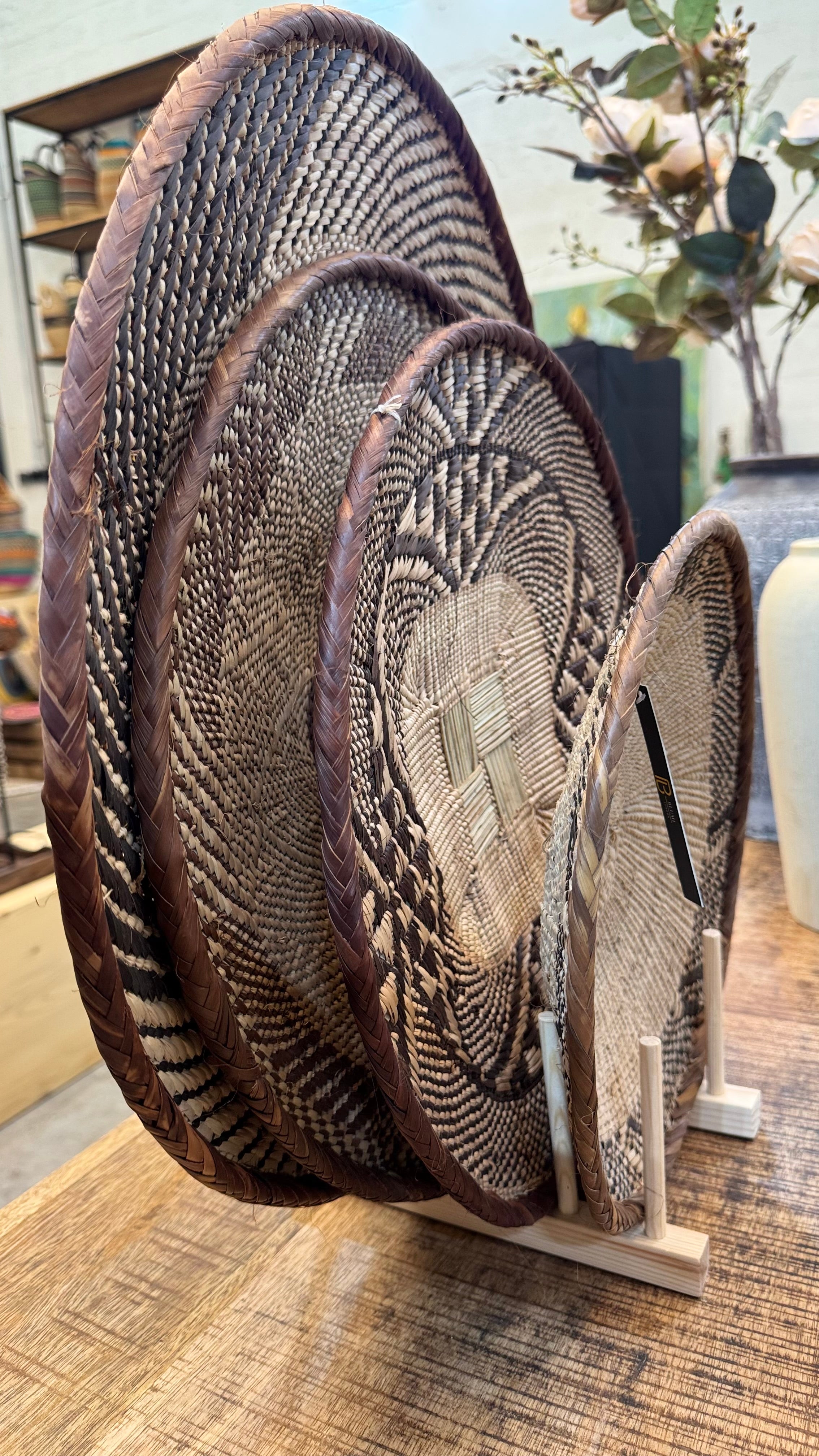 Set of 4 handwoven Binga baskets from Zimbabwe in varying sizes - styled as natural wall décor in Dubai and Middle Eastern homes.
