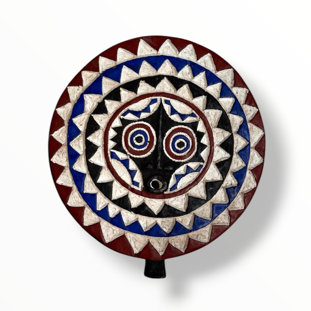 Bwa African sun mask with blue, red and black tones in a plain background