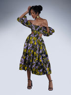 Brown girl wearing a purple and yellow cut out midi dress